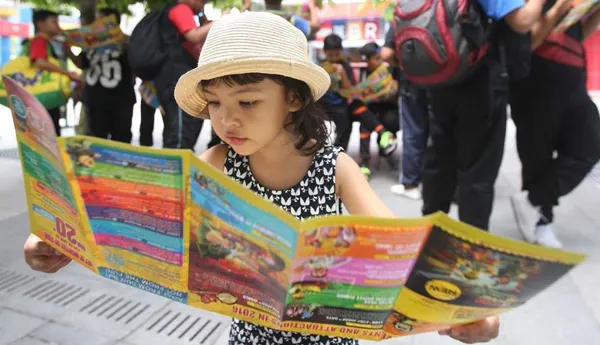Girl reading Park Brochure